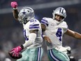 Ezekiel Elliott, left, and Dak Prescott of the Dallas Cowboys celebrate the fourth quarter touchdown against the Jacksonville Jaguars at AT&T Stadium on Oct. 14, 2018 in Arlington, Texas. (Ronald Martinez/Getty Images)