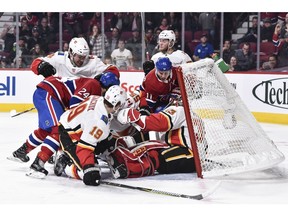 MONTREAL, QC - OCTOBER 23: Members of the Montreal Canadiens and Calgary Flames battle for the puck in front of Flames goaltender David Rittich #33 during the NHL game at the Bell Centre on October 23, 2018 in Montreal, Quebec, Canada.