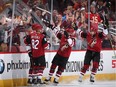 Richard Panik (14), Jordan Oesterle (82), Clayton Keller (9) and Alex Galchenyuk (17) of the Coyotes celebrate after Panik scored a goal against the Senators during the second period of Tuesday's game. Christian Petersen/Getty Images