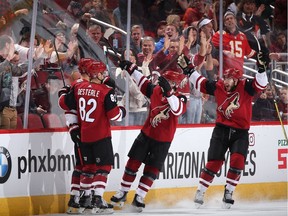 Richard Panik (14), Jordan Oesterle (82), Clayton Keller (9) and Alex Galchenyuk (17) of the Coyotes celebrate after Panik scored a goal against the Senators during the second period of Tuesday's game. Christian Petersen/Getty Images