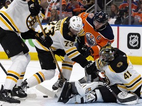 The Edmonton Oilers' Connor McDavid (97) battles the Boston Bruins' Zdeno Chara (33) Charlie McAvoy (73) and goalie Jaroslav Halak (41) during second period NHL action at Rogers Place, in Edmonton Thursday Oct. 18, 2018. Photo by David Bloom