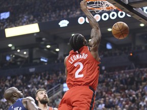 Raptors forward Kawhi Leonard throws down a dunk against the Minnesota Timberwolves on Wednesday night. (VERONICA HENRI/Toronto Sun)