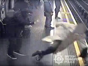 This undated handout grab taken from CCTV issued by British Transport Police shows Robert Malpas being pushed on to the tracks of Marble Arch Underground station in London.  (British Transport Police via AP)