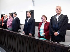 Defendant Angelika W (2nd R) with her lawyer Peter Wueller (R) and defendant Wilfried Max W (5th R) with his lawyers Carsten Ernst (6th R) and Detlev Binder (4th R) stand in a room of the district court in Paderborn, western Germany, on October 5, 2018. - The court jailed the couple who tortured and killed women they had lured to their village home in what has been dubbed the "House of Horrors" case. Angelika W, 49, received a 13-year prison sentence and her former husband Wilfried, 48, an 11-year term in a psychiatric ward for the abuse that led to the deaths of two women.