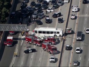 This aerial image made from video provided by KABC-TV shows the wreckage of a bus accident along Interstate 405 in Los Angeles on Sunday, Oct. 14, 2018. (KABC-TV via AP)