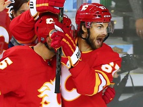 The Calgary Flames' Michael Frolik celebrates with Mark Giordano after Frolic scored his second goal of the night during NHL second period action against the Boston Bruins at the Scotiabank Saddledome in Calgary on Wednesday October 17, 2018.