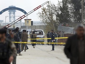 Security forces inspect the site of a suicide attack on prison employees' vehicle in Kabul, Afghanistan, Wednesday, Oct. 31, 2018. An Interior Ministry official says the suicide bomber has struck outside the country's largest prison on the eastern edge of the capital Kabul.