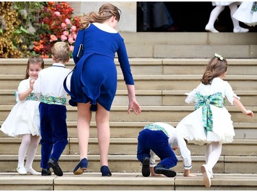 Princess Charlotte of Cambridge (L) arrives with bridesmaids and pageboys for the wedding of Britain's Princess Eugenie of York to Jack Brooksbank at St George's Chapel, Windsor Castle, in Windsor, on October 12, 2018.