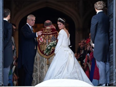 Britain's Princess Eugenie of York (R) arrives accompanied by her father Prince Andrew, Duke of York, (L) arrives to attend the wedding to Jack Brooksbank at St George's Chapel, Windsor Castle, in Windsor, on October 12, 2018.