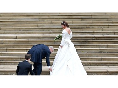 Britain's Princess Eugenie of York (R) arrives accompanied by her father Prince Andrew, Duke of York, (L) arrives to attend the wedding to Jack Brooksbank at St George's Chapel, Windsor Castle, in Windsor, on October 12, 2018.