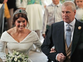 Princess Eugenie of York  walks up the aisle with her father Prince Andrew, Duke of York, to marry Jack Brooksbank during their wedding ceremony in St. George's Chapel, Windsor Castle, in Windsor, on Oct. 12, 2018. (YUI MOK/AFP/Getty Images)