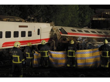Firefighters and emergency personnel carry on rescue operations after the Puyuma Express train derailed at high speed between Dongshan and Suxin in Taiwan's Yilan county on Oct. 21, 2018.