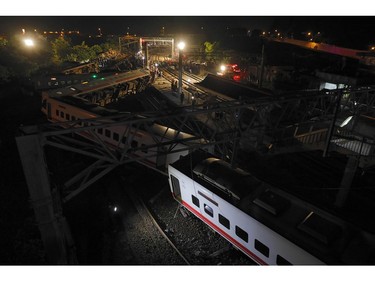Rescue workers check a derailed train in Yian, eastern Taiwan on October 21, 2018.