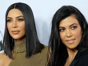 Kim Kardashian and Kourtney Kardashian attend the premiere of 'The Promise' at the Chinese theatre in Hollywood, on April 12, 2017.