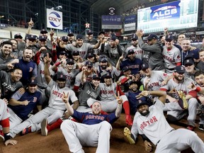 The Boston Red Sox pose for a picture after winning the baseball American League Championship Series against the Houston Astros on Thursday, Oct. 18, 2018, in Houston.
