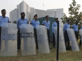 Pakistani police officers stand guard outside the supreme court in Islamabad, Pakistan, Wednesday, Oct. 31, 2018.