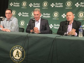 From left, Oakland Athletics manager Bob Melvin, executive vice president of baseball operations Billy Beane and general manager David Forst take part in a news conference about their long-term contract extensions in Oakland, Calif., Monday, Oct. 29, 2018.