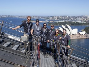 Britain's Prince Harry, left, Australia's Prime Minister Scott Morrison, second from left, and Invictus Games representatives climb the Sydney Harbour Bridge in Sydney, Tuesday, Oct. 19, 2018. Prince Harry and his wife Meghan are on day four of their 16-day tour of Australia and the South Pacific.
