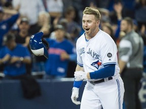 Toronto Blue Jays designated hitter Justin Smoak (14) reacts after hitting the game winning walk off home run to debated the Tampa Bay Rays during ninth inning AL baseball action in Toronto on Thursday, September 20, 2018.