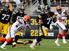Ben Roethlisberger of the Pittsburgh Steelers scrambles out of the pocket under pressure from Trevon Coley of the Cleveland Browns during the first half in the game at Heinz Field on Oct. 28, 2018 in Pittsburgh, Pa.