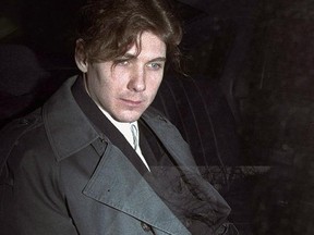 Paul Bernardo sits in the back of a police cruiser as he leaves a hearing in St. Catharines, Ont., April 5, 1994. (THE CANADIAN PRESS/Frank Gunn)