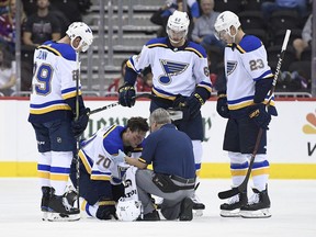 St. Louis Blues centre Oskar Sundqvist (70) is tended to by a trainer after he was checked by Washington Capitals right wing Tom Wilson, not seen, during a preseason game, Sunday, Sept. 30, 2018, in Washington.