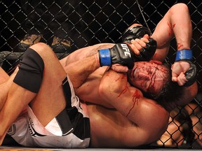 Stephan Bonnar is held by Mark Coleman during their light heavyweight bout during UFC 100 on July 11, 2009 in Las Vegas.