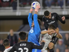 Toronto FC goalkeeper Alex Bono (centre) makes a save during Wednesday’s game against D.C. United in Washington. (AP PHOTO)