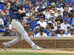 Brewers' Christian Yelich (22) hits an RBI single during the third inning of a tiebreak game against the Cubs on Monday, Oct. 1, 2018, in Chicago.