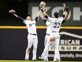 Ryan Braun #8, Lorenzo Cain #6 and Christian Yelich #22 of the Milwaukee Brewers celebrate after defeating the Los Angeles Dodgers in Game 6 of the National League Championship Series at Miller Park on Oct. 19, 2018 in Milwaukee, Wis.