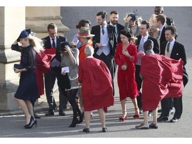 Chelsy Davy, left, and other guests hold onto their hats in the wind as they arrive for the wedding of Princess Eugenie of York and Jack Brooksbank at St George's Chapel, Windsor Castle, near London, England, Friday Oct. 12, 2018. (Andrew Matthews/Pool via AP) ORG XMIT: RWW115