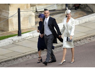 Robbie Williams, Ayda Field and Gwen Field, left, arrive for the wedding of Princess Eugenie of York and Jack Brooksbank at St George's Chapel, Windsor Castle, near London, England, Friday Oct. 12, 2018. (Aaron Chown/Pool via AP) ORG XMIT: RWW125