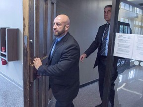 Darren Smalley, left, a British sailor charged with sexual assault causing bodily harm, heads from Supreme Court in Halifax on September 4, 2018. THE CANADIAN PRESS/Andrew Vaughan