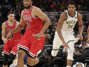 Milwaukee Bucks' Giannis Antetokounmpo tries to drive past Chicago Bulls' Jabari Parker during the second half of an NBA preseason basketball game Wednesday, Oct. 3, 2018, in Milwaukee.