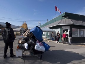 People gather outside a illegally operating cannabis store in Kamloops, B.C. Wednesday, Oct. 17, 2018.