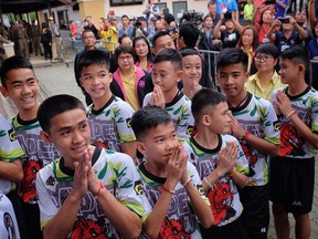 Twelve boys and their coach from the Wild Boars soccer team arrive for a press conference for the first time since they were rescued from a cave in northern Thailand last week, on July 18, 2018 in Chiang Rai, Thailand. (Linh Pham/Getty Images)