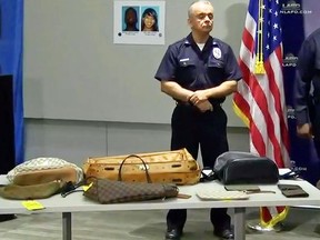 This photo from video provided by the Los Angeles Police Department shows some of the items recovered after the arrests of four people police say targeted celebrity homes for burglary, including those of Rihanna, Christina Milian, Los Angeles Dodgers baseball star Yasiel Puig and Los Angeles Rams NFL football wide receiver Robert Woods, at a news conference in Los Angeles, Tuesday, Oct. 2, 2018. (Los Angeles Police Department via AP)