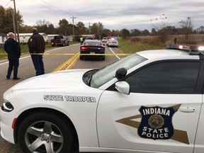 In this photo provided by WSBT 22, authorities work at the scene Tuesday, Oct. 30, 2018, near Rochester, Ind., where several children were struck and killed by a pickup truck as they were about to board a school bus. (WSBT 22 via AP)