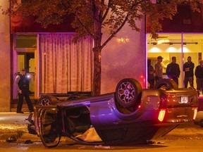 Chicago police investigate the scene of a fatal shooting early Monday, Oct. 1, 2018, in Chicago. Police said multiple men were fatally shot and others were shot and wounded during a dispute inside a moving car that ended in a rollover crash. (Tyler LaRiviere/Chicago Sun-Times via AP) ORG XMIT: ILCHS202
