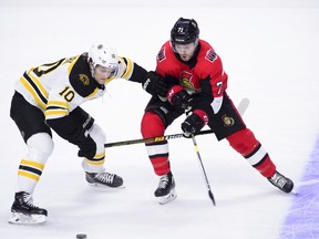 Bruins’ Anders Bjork (left) pushes Senators’ Chris Tierney off the puck during first-period action on Tuesday night in Ottawa. (Sean Kilpatrick/THE CANADIAN PRESS)
