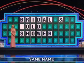 "Wheel of Fortune" presenter Vanna White is seen standing in front of a puzzle. (YouTube)
