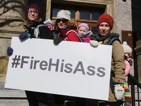 Hope Jamieson Baggs (left) and daughter Ruth, Kelly Hickey (centre) and daughter Violet, and Jen Daniels (right) with her child Casey helped organized a rally at police headquarters in St. John's on February 27, 2017 following a weekend of outrage after a Newfoundland officer was acquitted of sexual assault. (THE CANADIAN PRESS/Paul Daly)