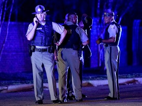 South Carolina state troopers gather on Hoffmeyer Rd. near the Vintage Place neighbourhood where several law enforcement officers were shot, one fatally, Wednesday, Oct. 3, 2018, in Florence, S.C.