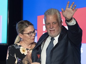 Quebec Liberal leader Philippe Couillard waves to supporters as his wife Suzanne Pilote looks on after he lost the general election to a majority CAQ government, Monday, October 1, 2018 in Saint-Felicien Quebec. (THE CANADIAN PRESS/Jacques Boissinot)