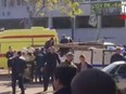 In this image made from video, showing the scene as emergency services load an injured person onto a truck, in Kerch, Crimea, Wednesday Oct. 17, 2018.  An explosive device has killed several people and injured at least 50 others at a vocational college in Crimea Wednesday in what Russian officials have called a possible terrorist attack. (Kerch FM News via AP) KERCH.FM LOGO CANNOT BE OBSCURED