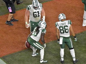 In this Sept. 20, 2018 photo New York Jets running back Isaiah Crowell (20) celebrates after scoring a touchdown during an NFL football game against the Cleveland Browns in Cleveland.