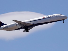 In this May 24, 2018, file photo a Delta Air Lines passenger jet plane, a Boeing 717-200 model, approaches Logan Airport in Boston.