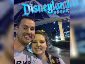 This Oct. 17, 2018 photo provided by Clark Ensminger, shows him with his wife Heather Ensminger at Disneyland in Anaheim, Calif. The couple visited four Disney parks in the Orlando, Fla., area and two Disney parks in the Los Angeles area, with a cross-country flight in between, all within 20 hours and two time-zone changes. (Clark Ensminger via AP)