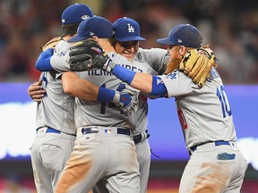 Manny Machado, Justin Turner, Enrique Hernandez and Cody Bellinger of the Los Angeles Dodgers celebrate after winning Game Four of the National League Division Series at Turner Field on October 8, 2018 in Atlanta. (Scott Cunningham/Getty Images)