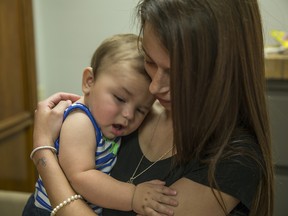 In this Aug. 3, 2016 photo, Mara Mancini, holds her son, Kyson Clark, in the law offices of Saeed and Little LLP on Aug. 3, 2016 in Indianapolis, Ind. (Michael Anthony Adams/IndyStar via AP)